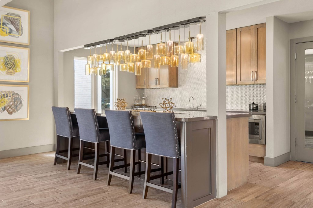 a kitchen with a bar with chairs and a chandelier a kitchen with a bar with chairs and a chandelier at South Lamar Village, Texas, 78704